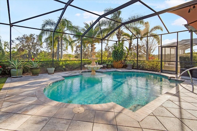 view of pool featuring a patio area and glass enclosure