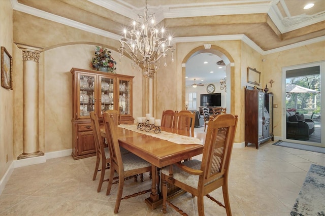 dining space with ornate columns, crown molding, and a towering ceiling