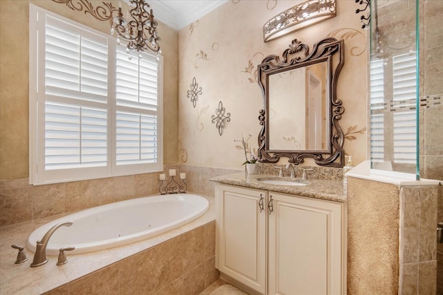 bathroom with a relaxing tiled tub, vanity, and crown molding