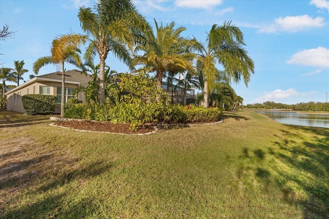 view of yard featuring a water view and a lanai