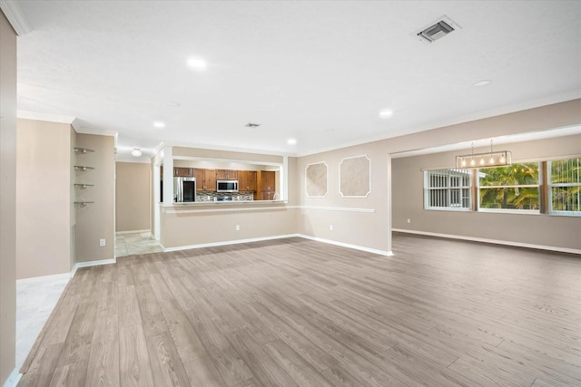 unfurnished living room with crown molding and light wood-type flooring