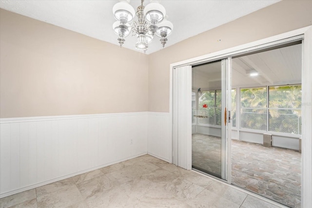 empty room featuring an inviting chandelier