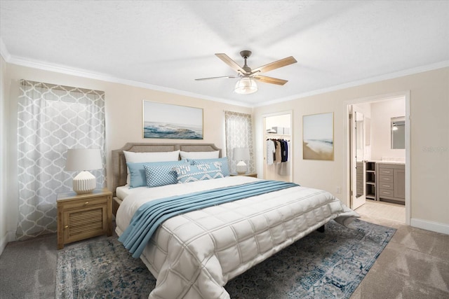 bedroom with a walk in closet, ornamental molding, light colored carpet, and a closet