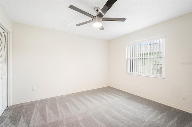 unfurnished room with ceiling fan and carpet flooring