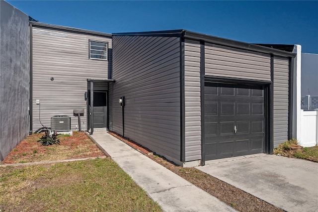 view of front of house with central AC unit and a front yard