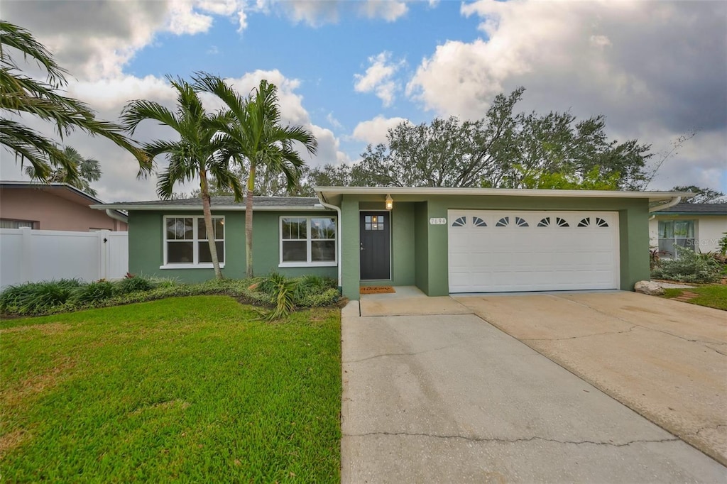 ranch-style home with a garage and a front yard