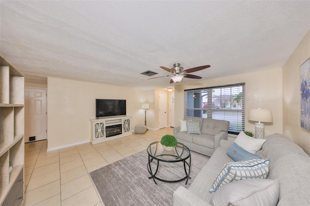 tiled living room featuring ceiling fan and a textured ceiling