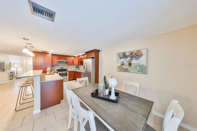 dining space featuring light tile patterned flooring