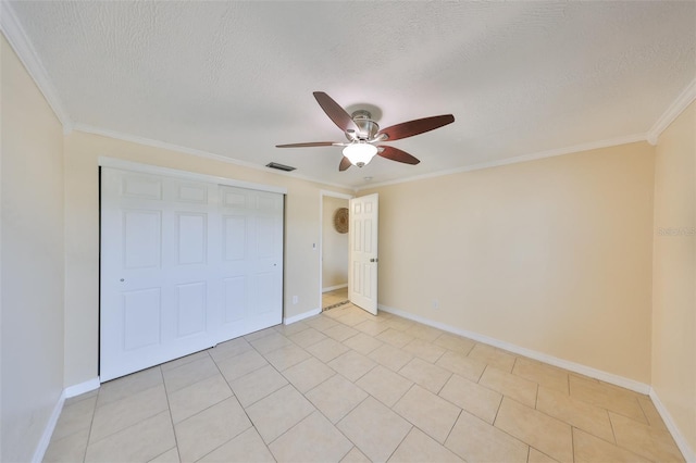 unfurnished bedroom with crown molding, a textured ceiling, light tile patterned floors, a closet, and ceiling fan