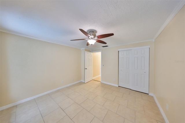 unfurnished bedroom featuring ceiling fan, crown molding, a closet, and a textured ceiling