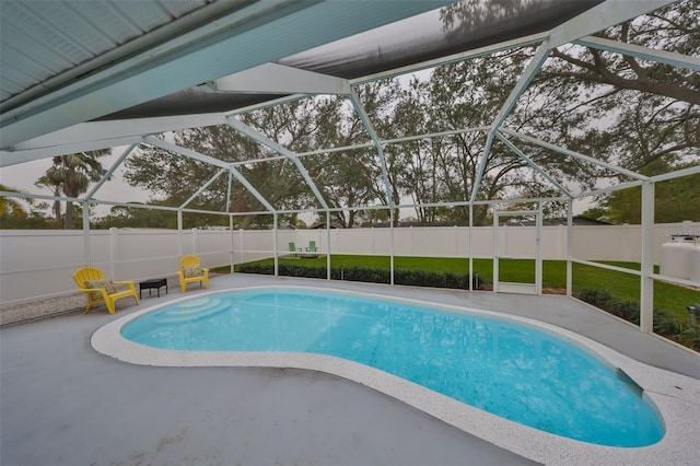 view of swimming pool featuring a lanai and a patio area