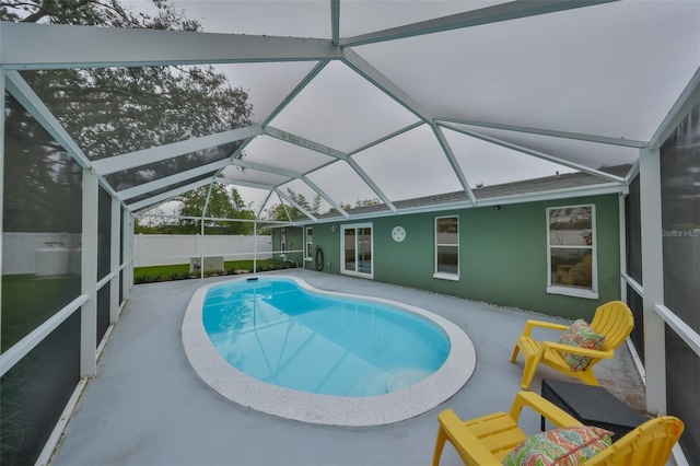 view of pool with a patio area and glass enclosure