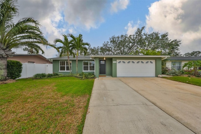 ranch-style home with a garage and a front lawn