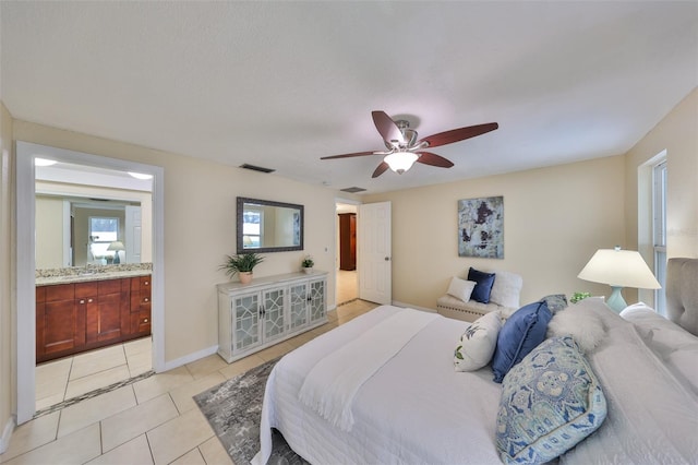 tiled bedroom with ceiling fan and ensuite bathroom