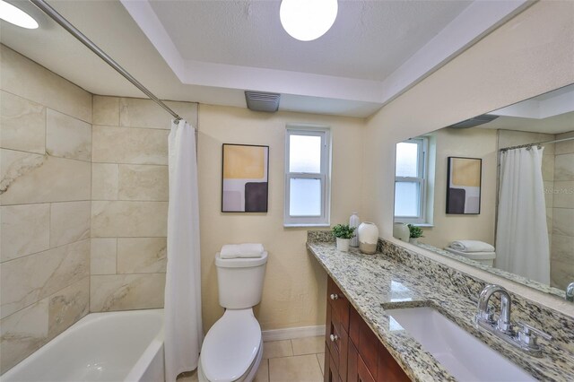 full bathroom with tile patterned floors, toilet, a textured ceiling, vanity, and shower / bathtub combination with curtain