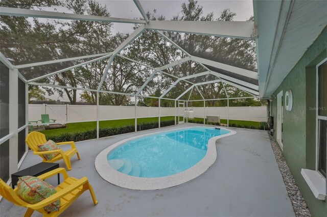 view of swimming pool with a patio and a lanai