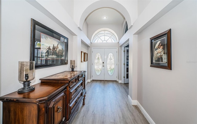 foyer entrance featuring french doors and light hardwood / wood-style flooring