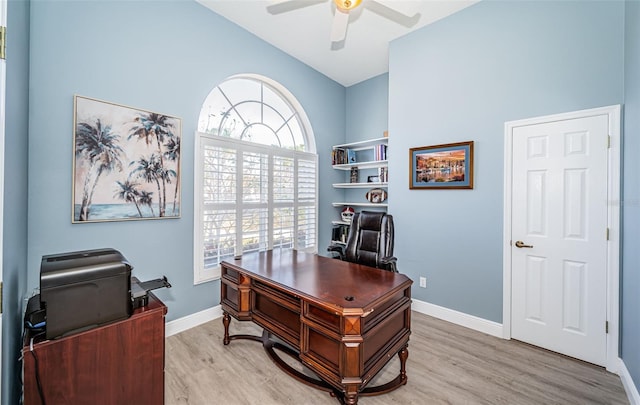 home office with light hardwood / wood-style floors and ceiling fan