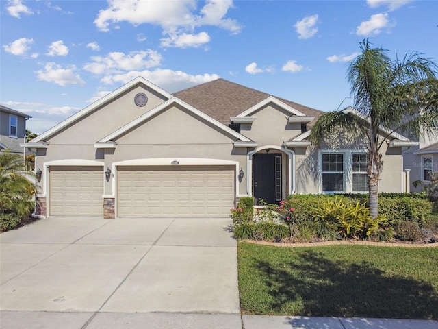 view of front of house with stucco siding, driveway, stone siding, an attached garage, and a shingled roof