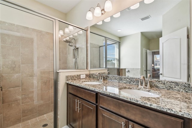 bathroom with vanity and a shower with shower door