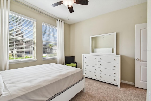 bedroom featuring baseboards, ceiling fan, and carpet floors