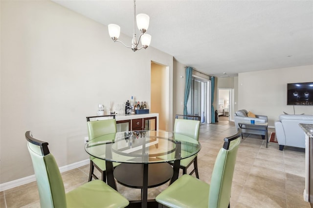 dining area featuring a notable chandelier and light tile patterned floors