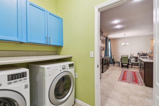 washroom featuring visible vents, independent washer and dryer, a sink, cabinet space, and a chandelier