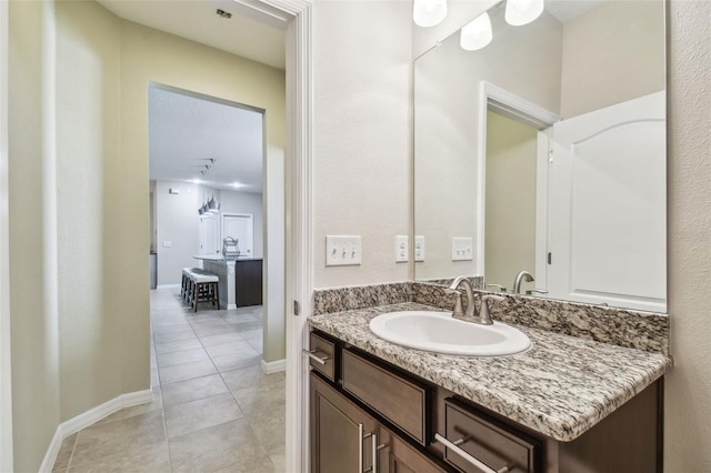 bathroom featuring vanity, tile patterned floors, and baseboards