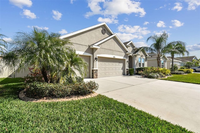 view of front of home with stucco siding, concrete driveway, a garage, and a front yard