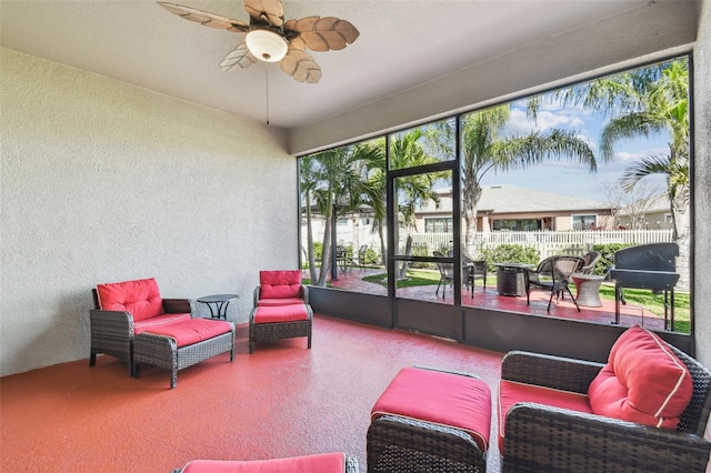 sunroom featuring ceiling fan