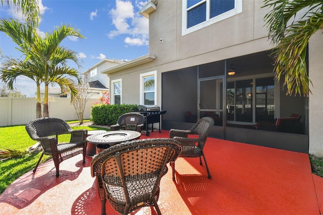 view of patio / terrace with fence, a sunroom, and grilling area