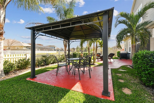 view of patio with a gazebo, grilling area, a residential view, and fence