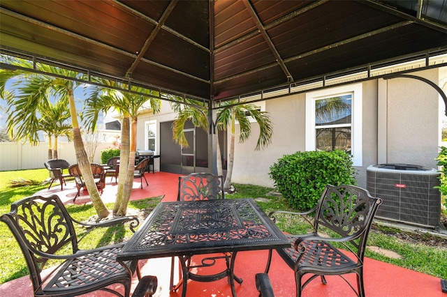 view of patio featuring central air condition unit, outdoor dining area, grilling area, and fence