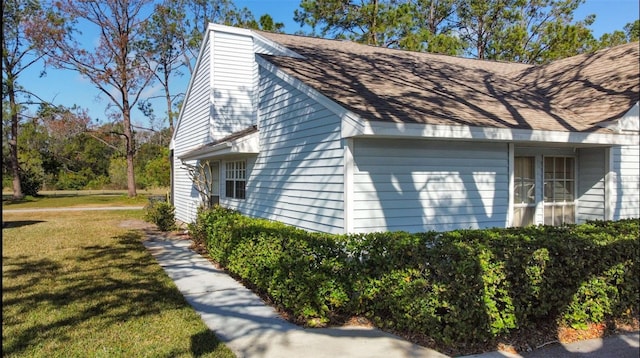 view of side of home featuring a lawn