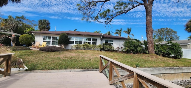 rear view of house with a yard and a patio