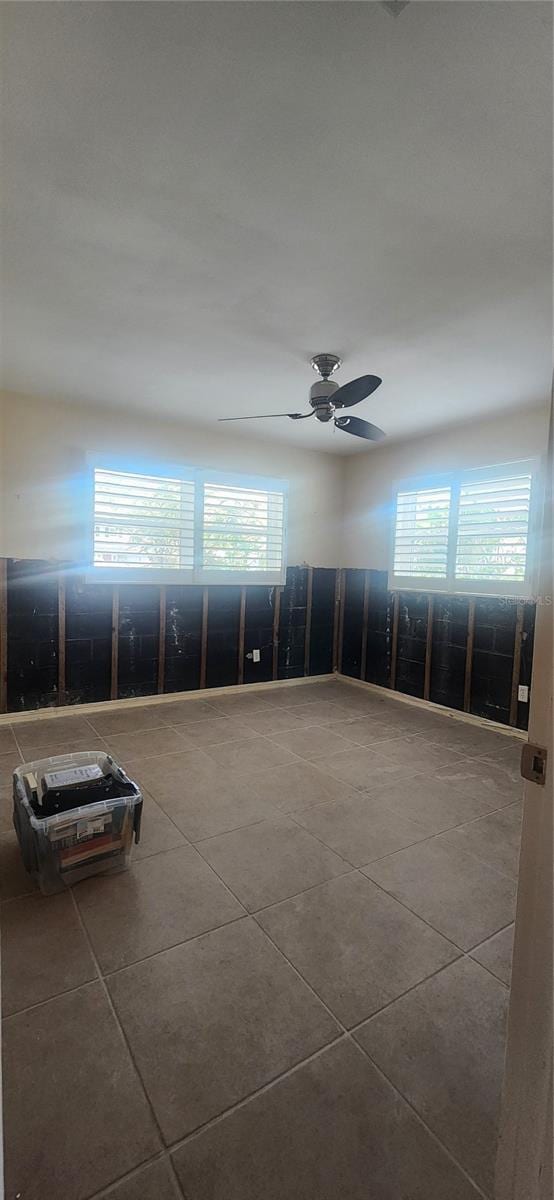 unfurnished room featuring ceiling fan and tile patterned flooring