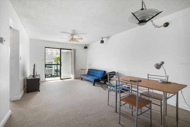 home office featuring carpet floors, a textured ceiling, and ceiling fan