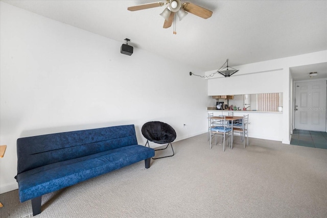 living area featuring carpet and ceiling fan