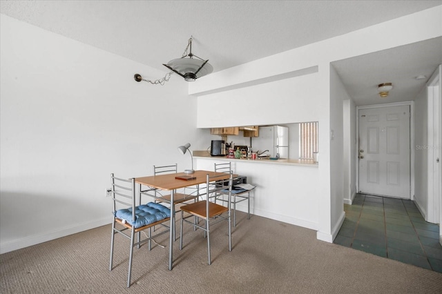 view of carpeted dining space