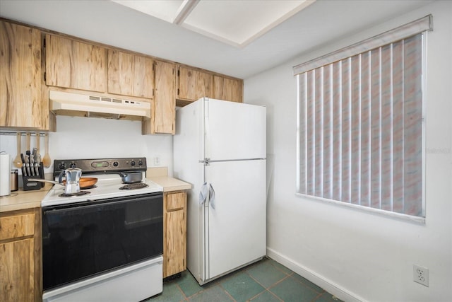 kitchen with dark tile patterned flooring and white appliances