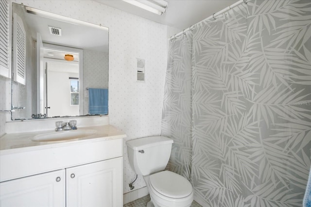 bathroom with vanity, curtained shower, and toilet