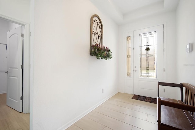 entryway featuring a raised ceiling