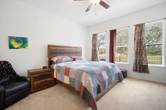 bedroom featuring light colored carpet and ceiling fan