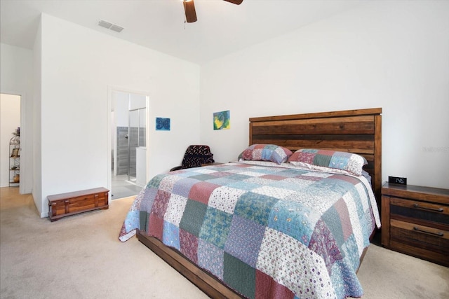 carpeted bedroom featuring ceiling fan and ensuite bathroom