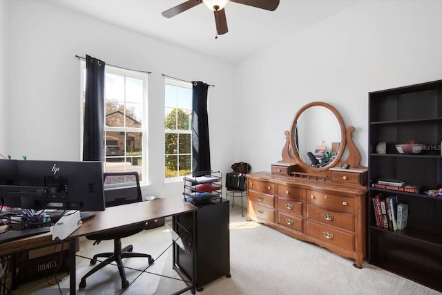 carpeted office featuring ceiling fan