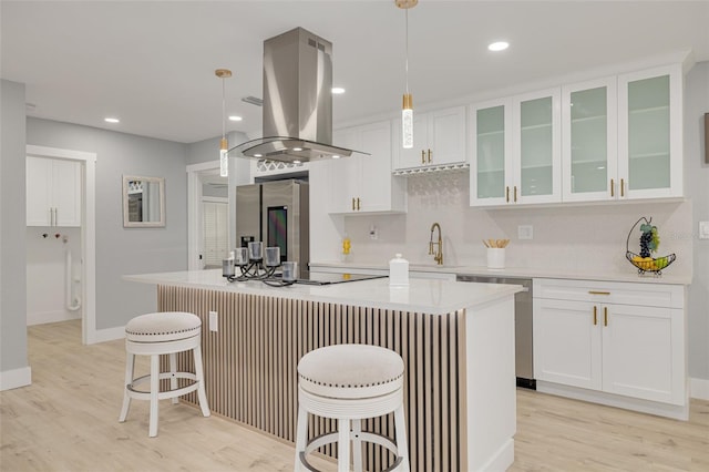 kitchen featuring pendant lighting, a kitchen island, appliances with stainless steel finishes, and island exhaust hood