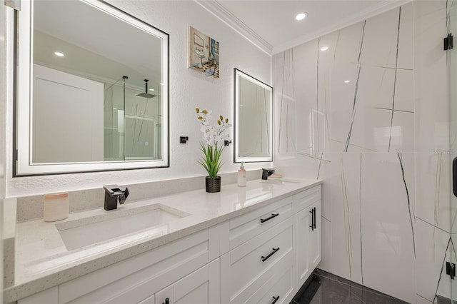 bathroom with vanity, a shower with door, and ornamental molding