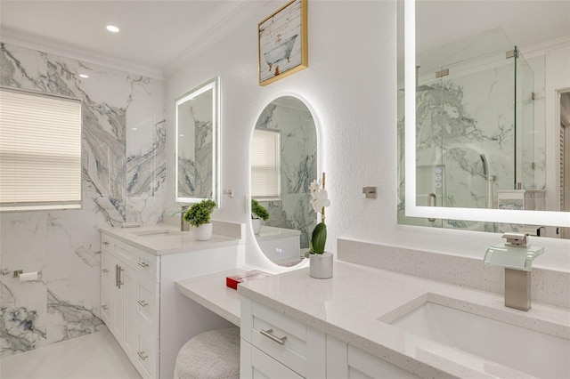 bathroom with vanity, crown molding, and a shower with door