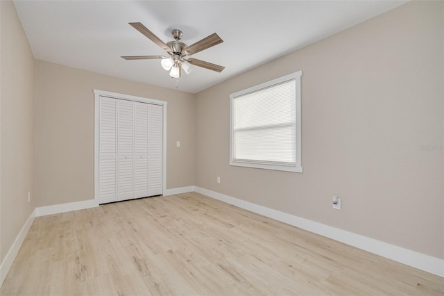 unfurnished bedroom with a closet, ceiling fan, and light wood-type flooring