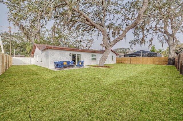 rear view of house with a lawn, outdoor lounge area, and a patio